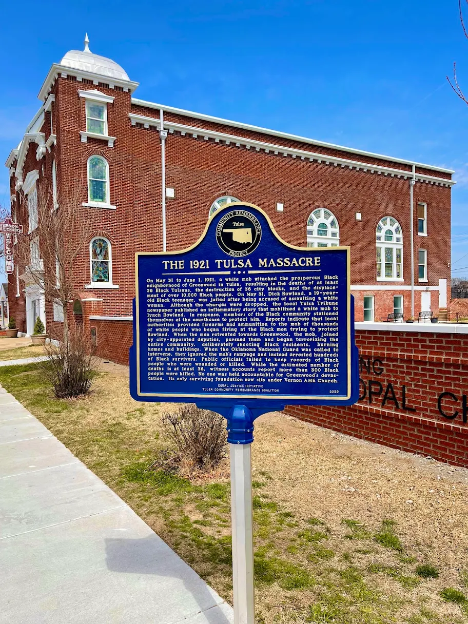 The 1921 Tulsa Massacre historic marker in front of Vernon AME Church, the site's surviving foundation, in Greenwood