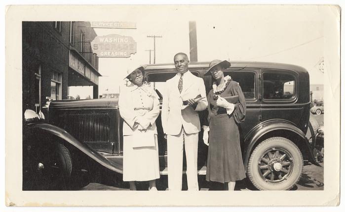 Archival photograph of S.M. Jackson and two women beside a vintage automobile in Greenwood, part of Princetta Rudd Newman's personal collection